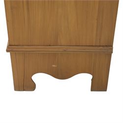 Edwardian stained pine dressing chest, the moulded top over three graduating drawers with pressed brass handles, shaped apron and bracket feet, the mirror back with rectangular plate on pivot supports, flanked by pierced Gothic style uprights with small corner shelves