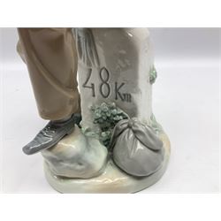 Lladro figure, Violinist, modelled as a man seated upon a  mile stone holding a violin, sculpted by Salvador Furió, no 4887,  year issued 1984, year retired 1981, H35cm