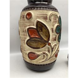 Pair of Bay West German vases, with bold moulded flower and foliage decoration in green, orange and ochre on brown ground, largest H40cm