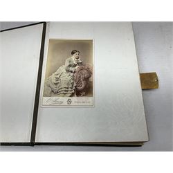 Victorian photograph album with ornately gilded and hand painted covers and brass clasp, partially stocked with Victorian and later portraits etc; another well stocked Victorian leather bound photograph album relating to the Cawood family; three other Victorian leather bound photograph albums; and small quantity of stereoscopic cards