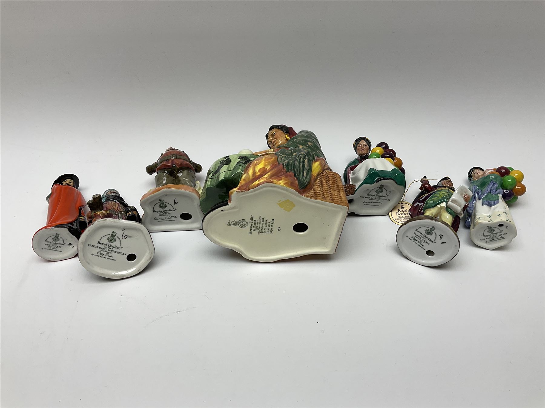 A group of Royal Doulton figures, comprising Fortune Teller HN2159, Guy Fawkes HN3271, Falslaff HN3236, Town Crier HN3261, The Balloon Seller HN2130, Good King Wenceslas HN3262, and Old Balloon Seller HN2129, six small examples with makers box. 