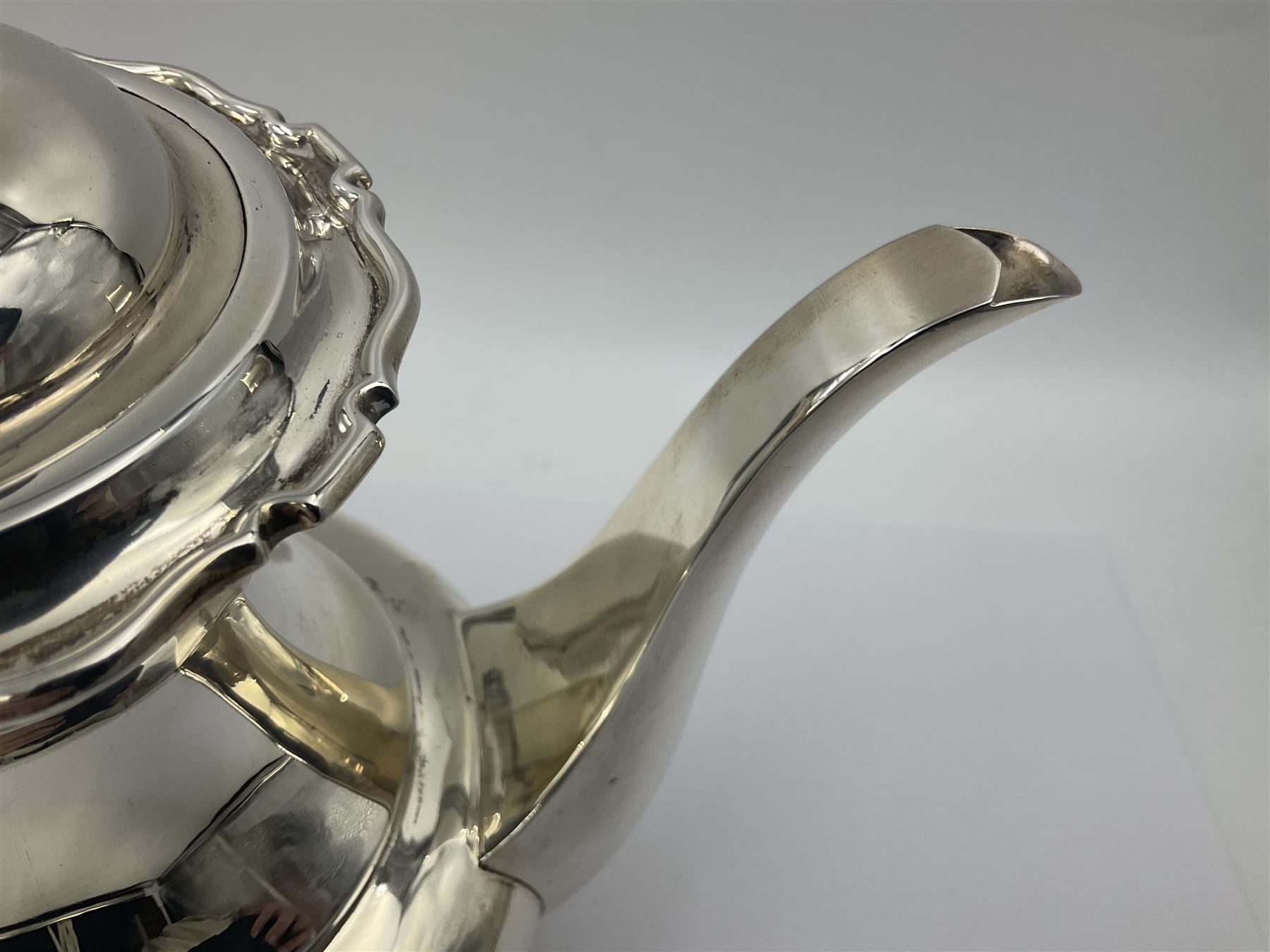 1920s five-piece silver tea service, comprising teapot, coffee pot, hot water pot, twin handled open sucrier and milk jug, each of squat circular form with shaped rim, the teapot, coffee pot and hot water pot each with ebonised handle and finial, the sucrier and milk jug with acanthus capped scroll handles, all upon circular foot, hallmarked R F Mosley & Co, Sheffield 1926 & 1927, tallest H24cm