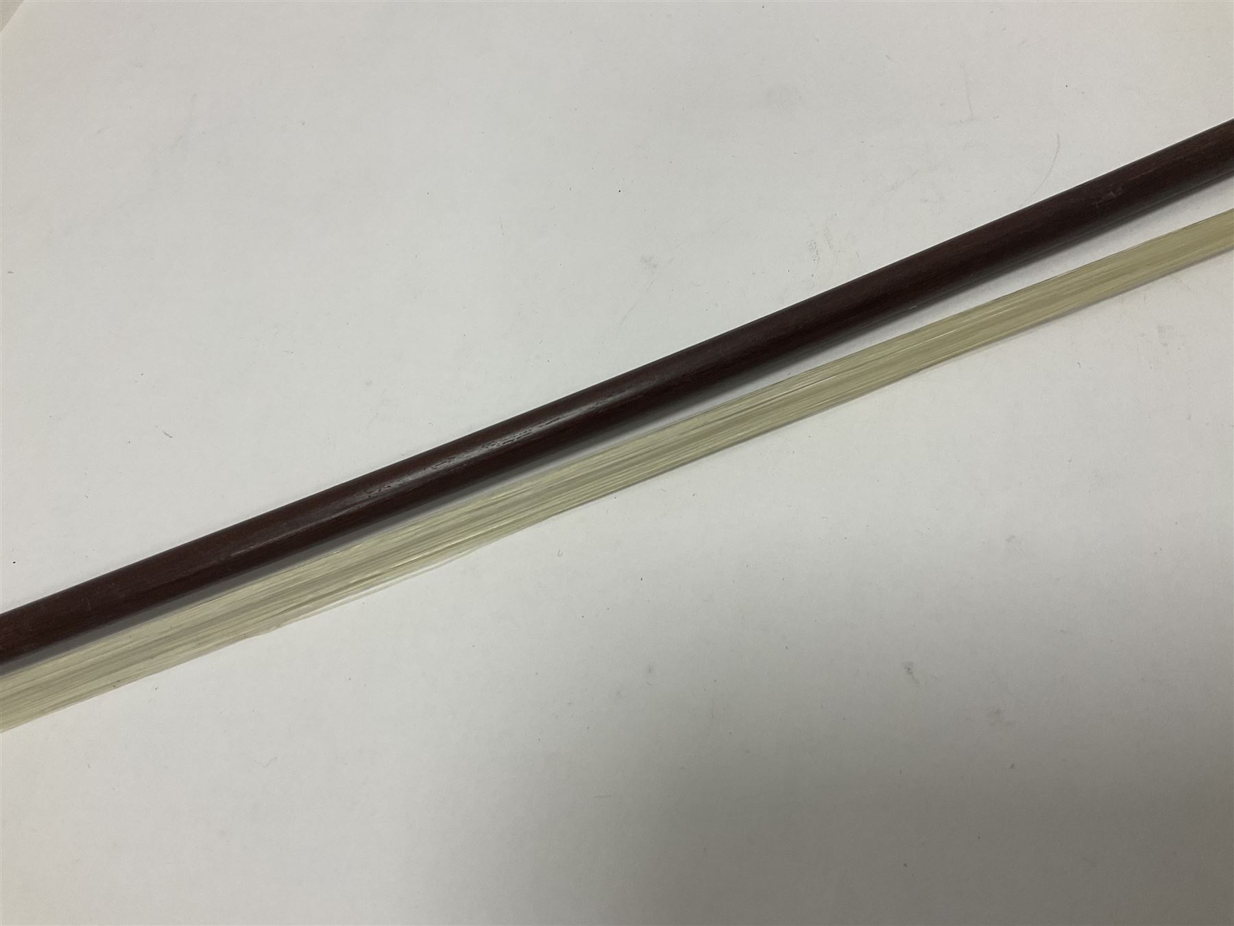 19th century wooden violin bow with a decorative mother of pearl inlay depicting flowers to the frog, with a bone adjuster screw