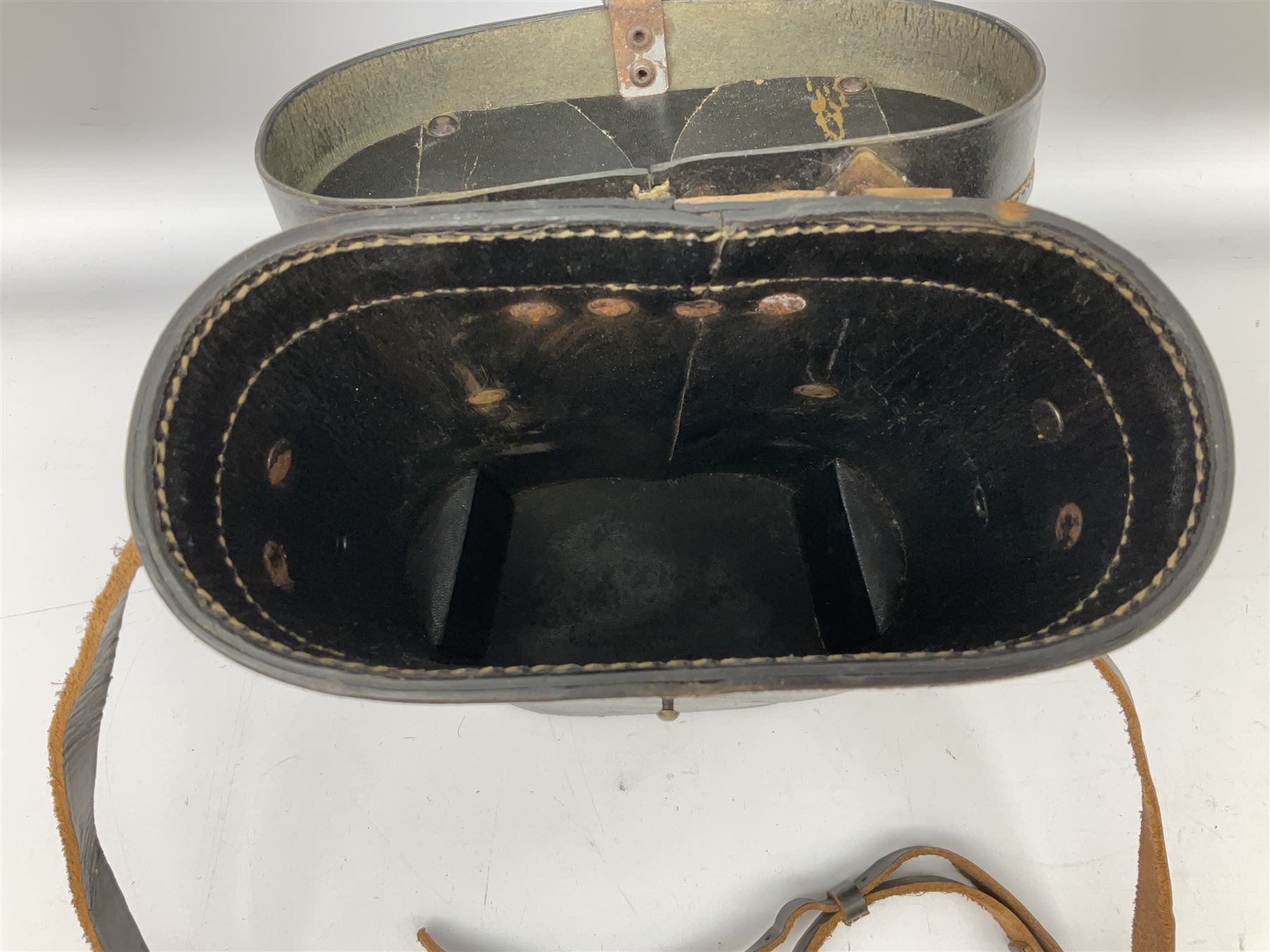 Pair of WWII German U-boat binoculars probably 7 x 50 by Leitz, with rubber eye piece protector covers and leather case stamped with Kriegsmarine mark to the lid and dated 1944, with leather strap.