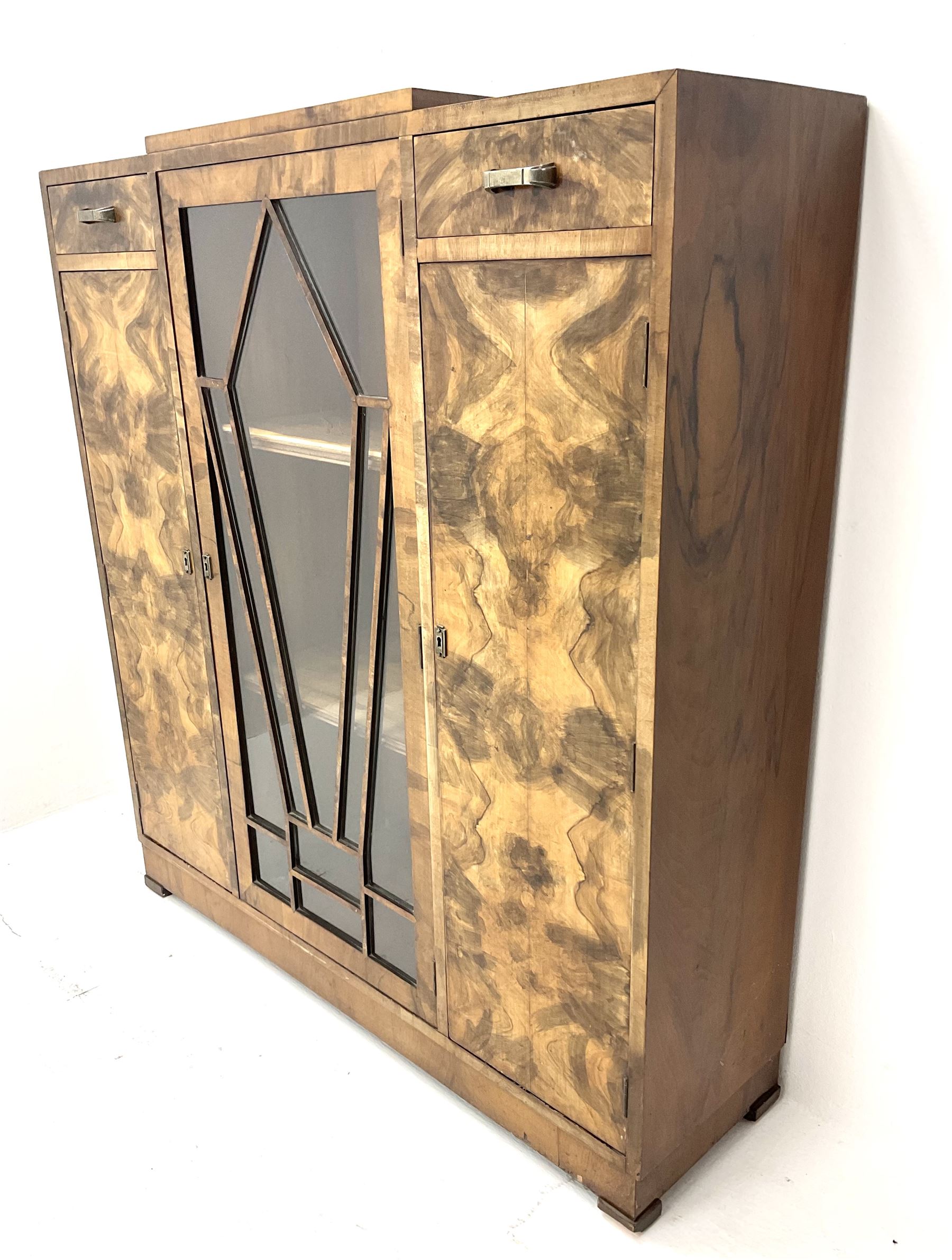 Art Deco walnut display cabinet, central astragal glazed door flanked by two drawers and two cupboards 