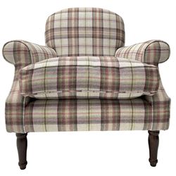 Traditional shape armchair, upholstered in pink and lilac checkered fabric, rolled arms with loose seat cushion, on turned front supports 