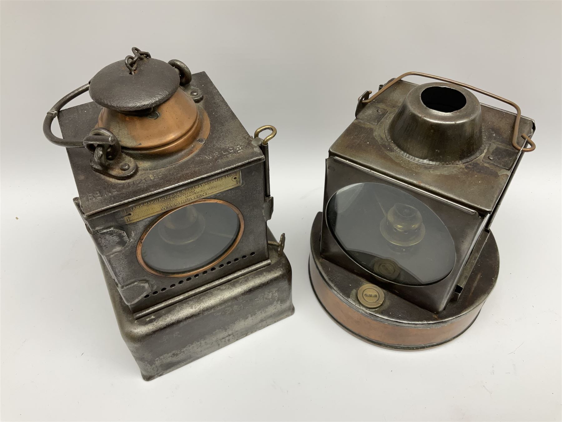 Lamp Manufacturing & Railway Supplies Ltd Welch Patent steel and copper railway lamp marked LNER, with square base marked 'S', H25cm; together with another similar railway lamp with circular base, the reservoir stopper marked GWR (2)