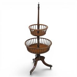 Regency style oak two-tier dumb waiter, with turned finial above central column support, two circular spindle-galleried basket tiers, raised on downswept tripod supports with brass caps and castors