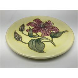 Moorcroft Tiger Lily pattern plate on a yellow ground, with painted and impressed mark beneath, D26cm