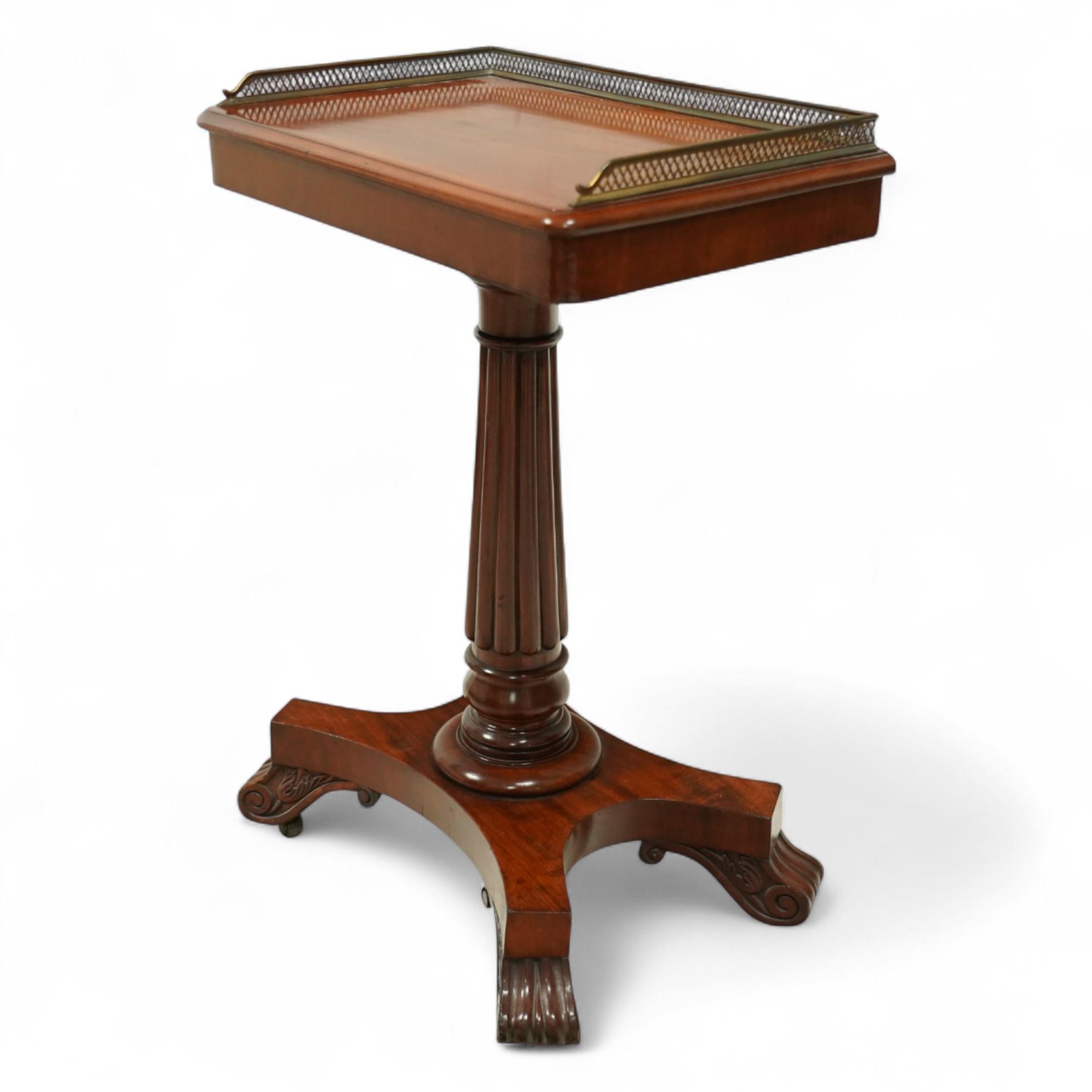 Late Regency mahogany side table in the manner of Gillows, the rectangular top with pierced brass gallery, raised on a reeded column and quatreform base with scroll carved feet with castors 