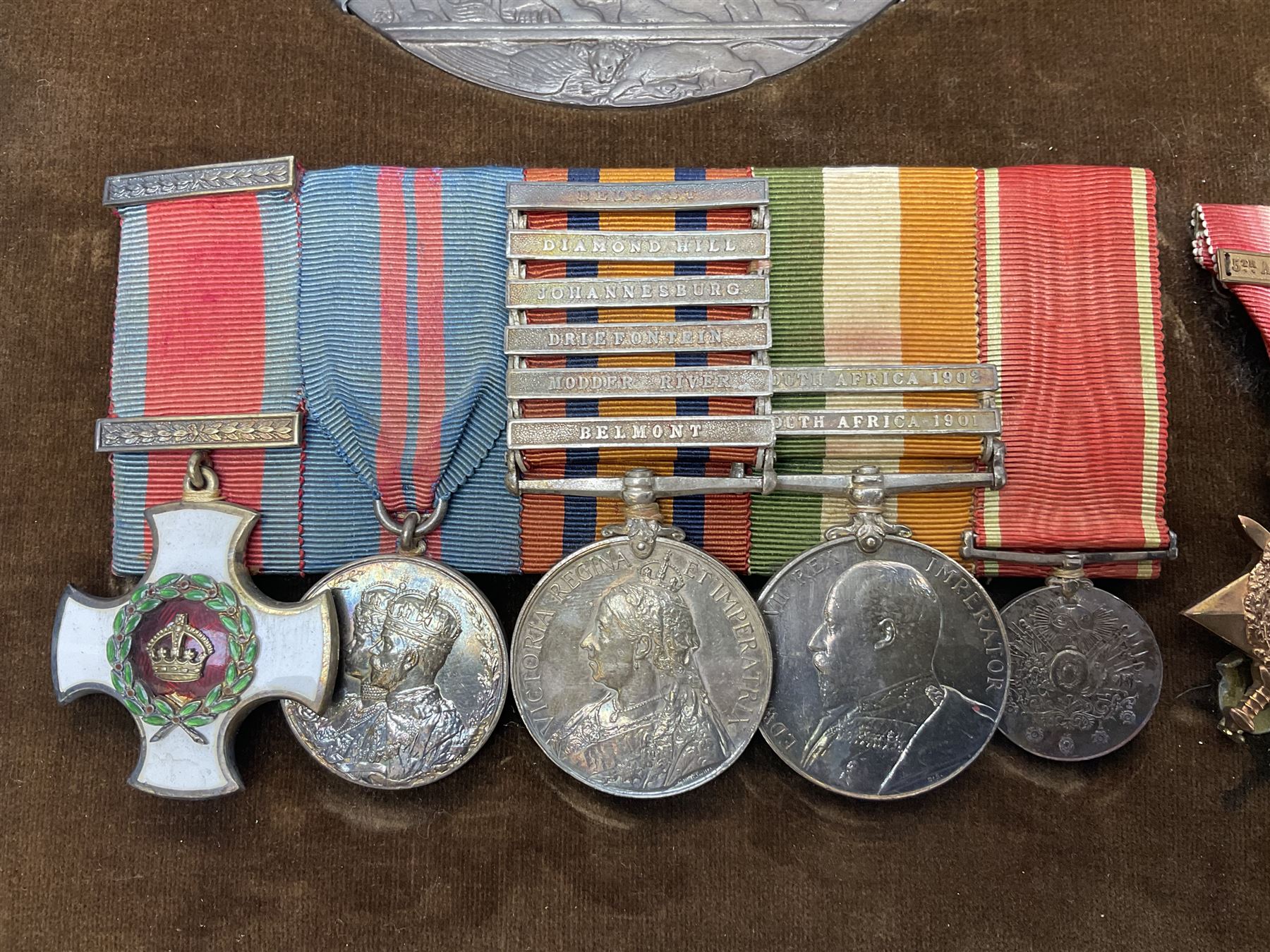 KIA (Ypres)  DSO group of eight Boer War/WW1 medals comprising Victorian DSO, Queens South Africa Medal with six clasps for Belmont, Modder River, Driefontein, Johannesburg, Diamond Hill and Belfast, Kings South Africa Medal with two clasps for South Africa 1901 and South Africa 1902, Turkish Liakat Medal, WW1 1914 Star with 5th Aug - 22nd Nov 1914 bar, British War Medal and Victory Medal and George V 1911 Coronation Medal, awarded to Lieutenant (later Captain) Albert Alexander Leslie Stephen Scots Guards; the group of six Boer War miniatures including additional Turkish Order of the Medjedie 3rd Class with rosette; all with ribbons and later mounted and framed with his bronze memorial plaque; together with Cecil Cutler (active 1886-1934) heightened watercolour three-quarter length portrait of Stephen in uniform, signed and dated 1915, 52 x 35cm; gilt frame;
Auctioneer's note: STEPHEN, ALBERT ALEXANDER LESLIE, Lieutenant, was born 3rd February 1879, son of Major J Z Stephen and Augusta Henrietta Mary (nee Ricketts). He was educated at Eton, and joined the Scots Guards 4th January 1899, becoming Lieutenant 4th April 1900. He served in the South African War, in which he was present at a large number of engagements. He took part in the advance on Kimberley, with the action at Behnont, and was present at Enslin, Modder River and Magersfontein, and also at the operations in the Orange Free State, Transvaal, Orange River Colony and Cape Colony, including actions at Poplar Grove, Driefontein, Vet and Zand Rivers; the action near Johannesburg, those at Pretoria, Diamond Hill and Belfast. From January 1901, he was Assistant Provost-Marshal to Pulteney's Column, and he was Intelligence Officer to Garrett's Column in 1902. He was twice mentioned in Despatches [London Gazette, 10 September 1901, and 29 July 1902]; received the Queen's Medal with six clasps; the King's Medal with two clasps, and was created a Companion of the Distinguished Service Order [London Gazette, 31st October 1902]: 