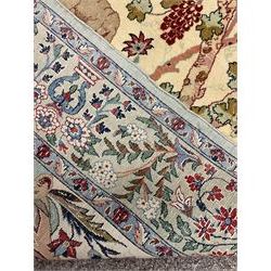 Fine Persian tree of life rug wall hanging, ivory ground field depicting landscape filled with animals, birds and flowers, the guarded border with stylised flower heads and foliage decoration, with brass hanging rail