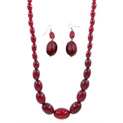 Single strand cherry amber bead necklace, with pair of matching pendant earrings