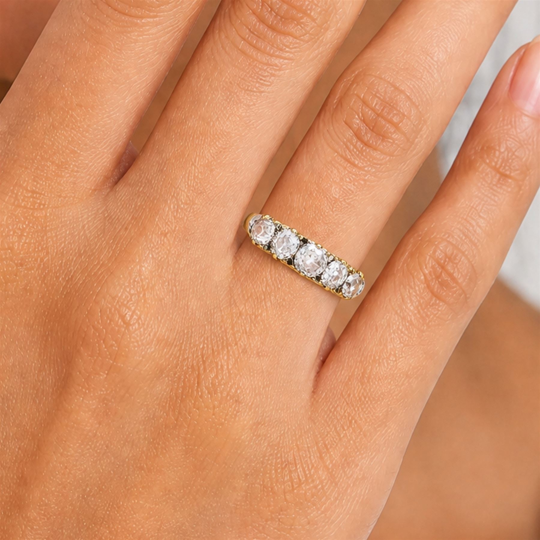 Early 20th century 18ct gold diamond ring, set with five graduating old cut diamonds and diamond accents, total diamond weight approx 1.55 carat