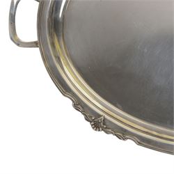 Modern silver twin handled serving tray, of oval form with stylised bud and tendril detail to rim, hallmarked Garrard & Co Ltd, Sheffield 1970, also impressed Garrard & Co Ltd 112 Regent Street beneath, including handles L64cm
