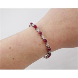 18ct white gold ruby and diamond bracelet, fifteen oval cabochon cut rubies, each spaced by four round brilliant cut diamonds, Sheffield 2009, total ruby weight 10.10 carat, total diamond weight approx 0.60 carat