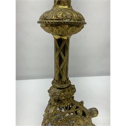Pair of gilt metal pricket candlesticks, with applied decoration on knopt stems and triform bases, H47cm