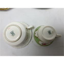 Coalport green batwing pattern tea wares, decorated with finely enamelled floral sprays within gilt reserves, comprising teacup trio, twin handled cake plate and side plate, pattern no Y2665, together with a Coalport for Harrods cup and saucer similarly decorated, the saucer with stamped mark beneath 'Manufactured for Harrods Ltd, Brompton Rd London', all with green Coalport AD 1750 marks beneath, largest W31cm (7)