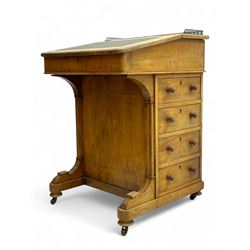 Early 19th century burr walnut Davenport desk, sloped leather-inset writing surface with brass gallery, fitted with an inkwell compartment and pen slot, four drawers to one side, raised on scrolled supports terminating in castors