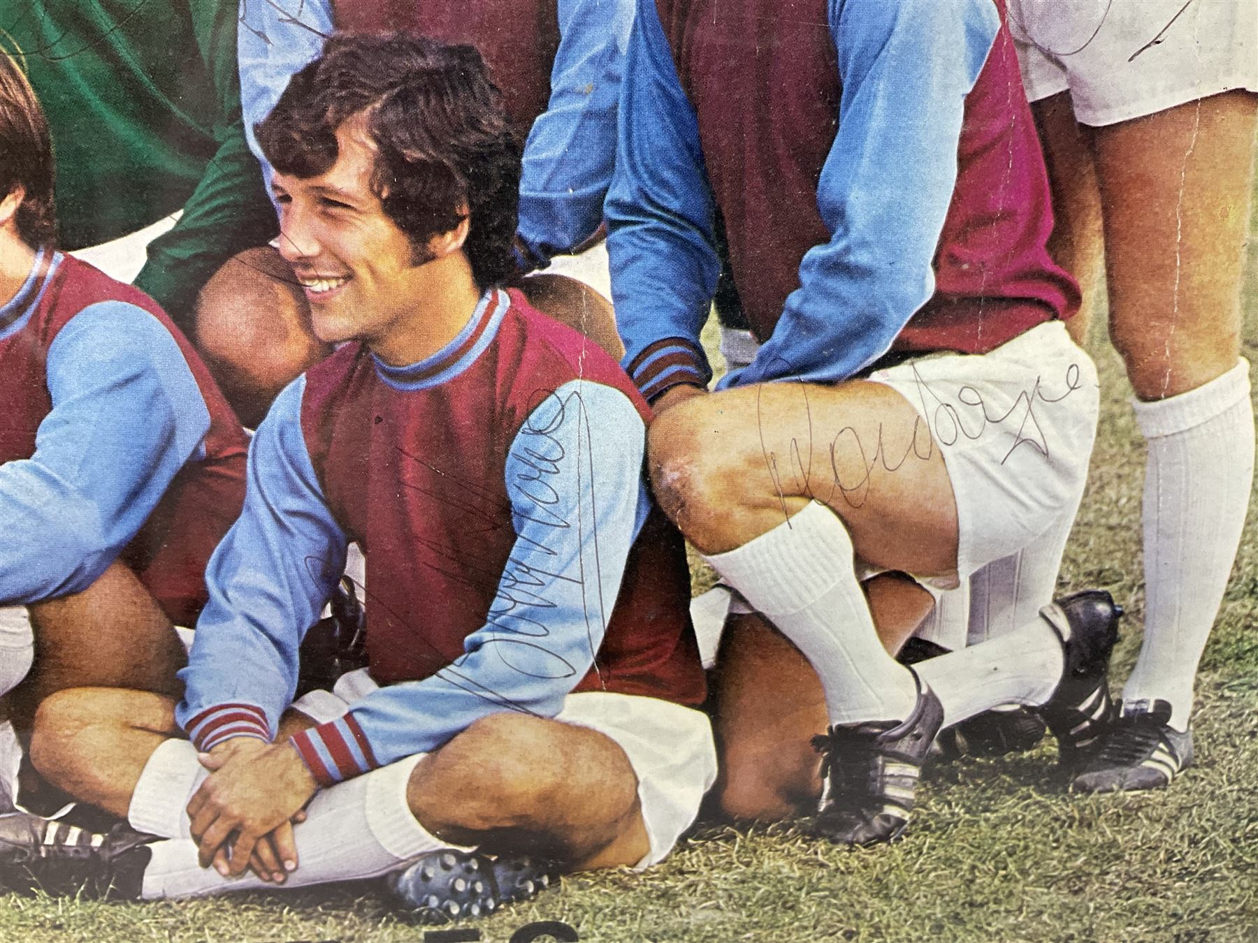 1970-1 photograph of West Ham United FC squad members, including Bobby Moore, Geoff Hurst, Harry Redknapp, Trevor Brooking, Jimmy Greaves, Billy Bonds etc, most players with signatures, 30 x 45cm, framed and glazed