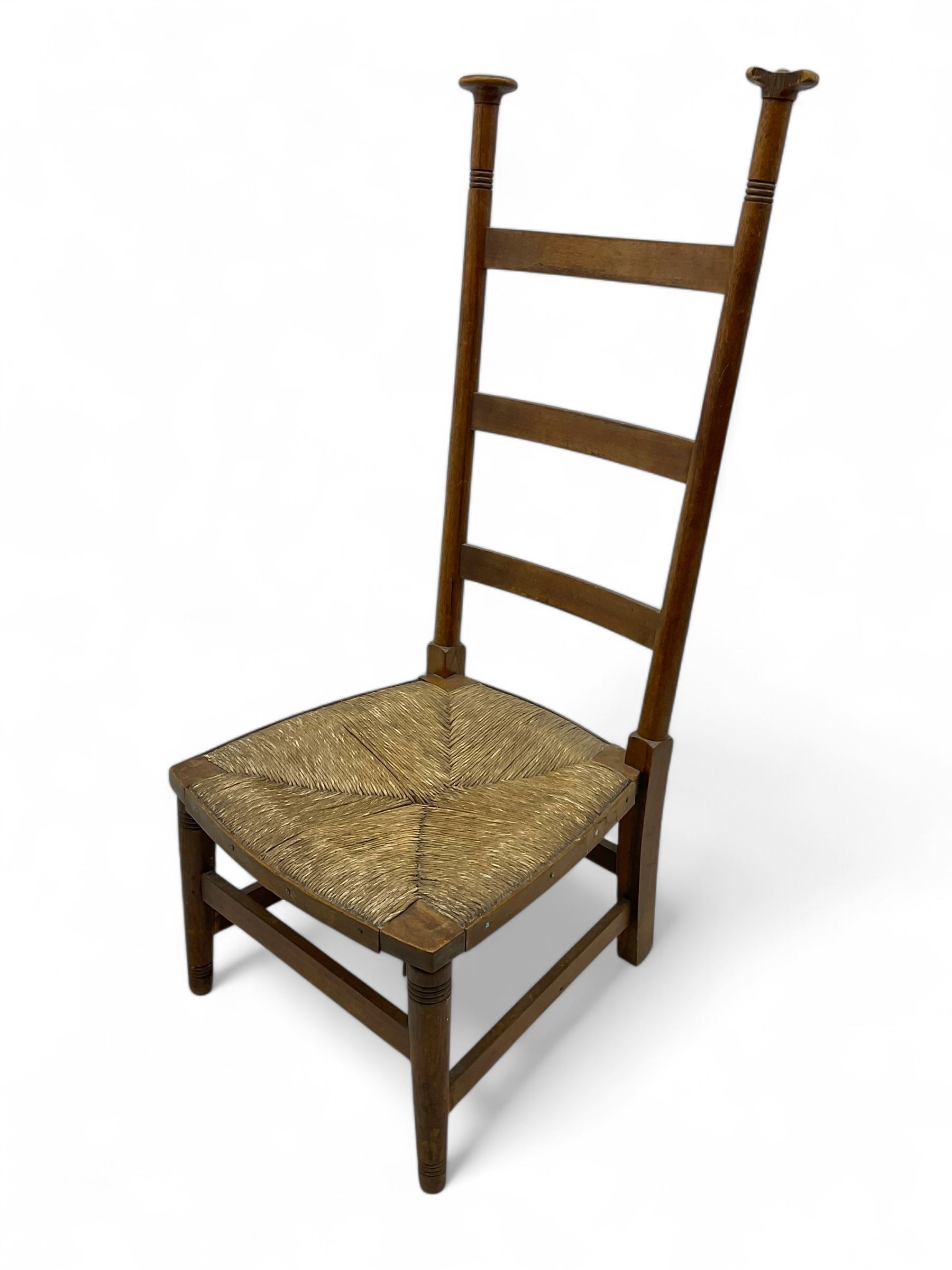 Attributed to William Birch of High Wycombe - Arts & Crafts oak ladder-back side chair, with turned finials, rush seat, and stretchers, raised on square-section supports; 19th century mahogany Pembroke table, rectangular drop-leaf top raised on turned supports with central stretcher and splayed feet