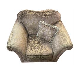 Armchair upholstered in plum fabric decorated with raised floral repeating pattern, with scatter cushions 