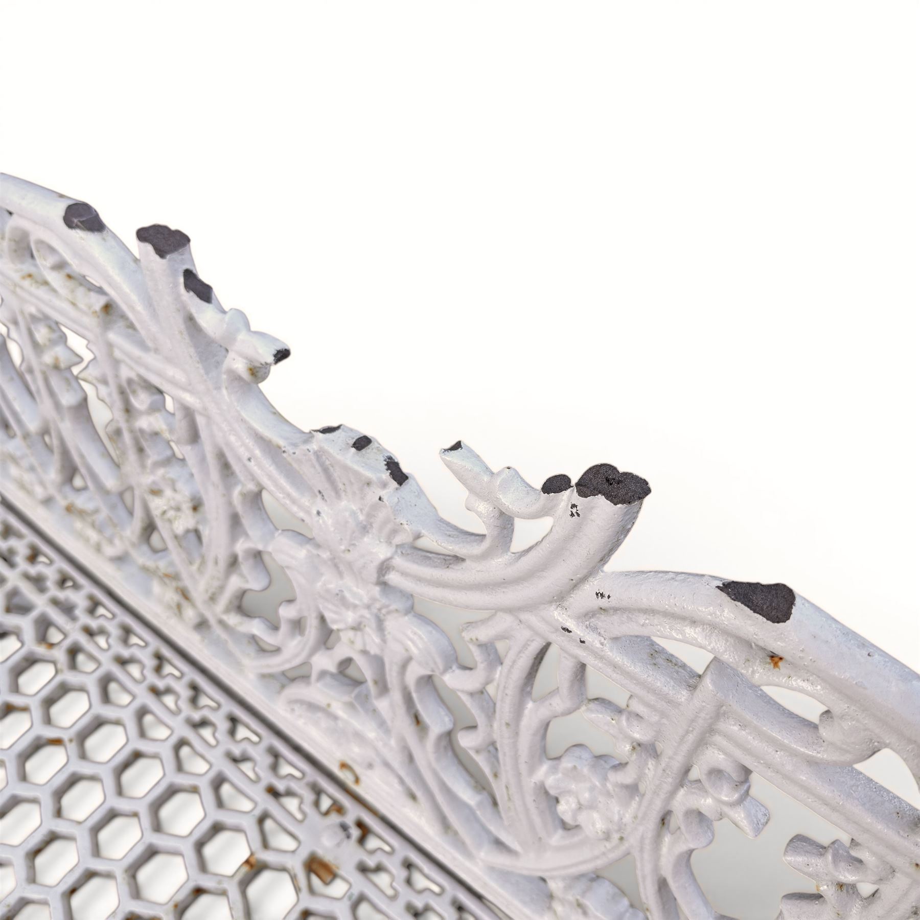 Victorian revival heavy cast iron garden bench, ornate back rest with scrolls, floral motifs and central crest, pierced lattice seat, curved arms and decorative legs, painted in antique white, in the Gothic Coalbrookdale style - Damaged 