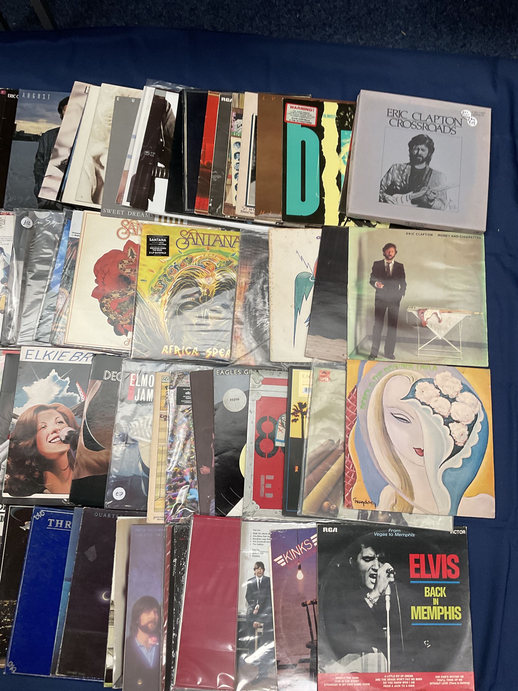 Quantity of vinyl records including Eagles 'Desperado', Electric Light Orchestra 'Balance Of Power', Rush '2112', 'Moving Pictures', Santana 'Festival', Eric Clapton 'No Reason To Cry' and other music, approximately 90, in one box