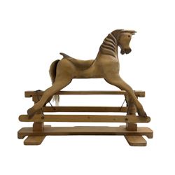  Terry White for White Horses (Hertfordshire 20th century) - Carved pine rocking horse, raised on a pine trestle base