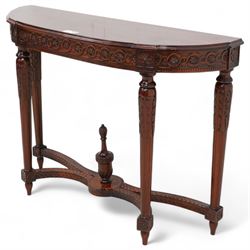 Mahogany demi-lune console table, moulded top over flower head guilloche decorated frieze, on turned and acanthus carved supports with fluted decoration, united by shaped stretchers with central finial 