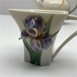 Franz Teapot decorated with dragonflies, together with a matching sucrier and cover and a cup and saucer in Iris pattern, all with printed mark beneath 