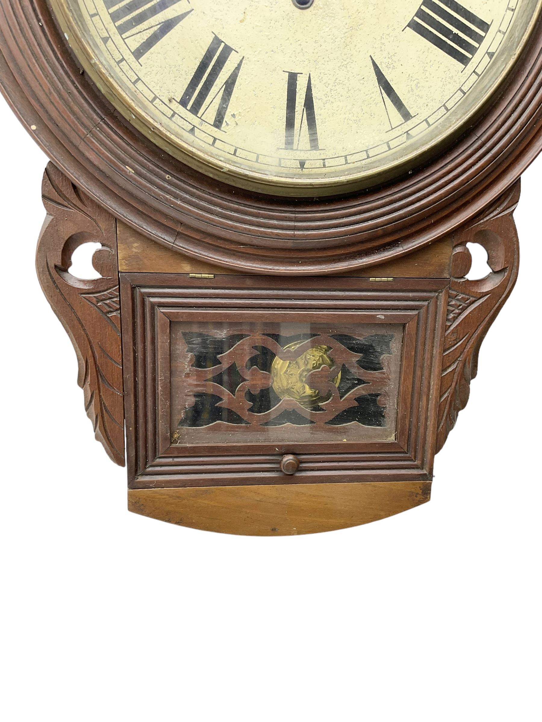 Richard Smith & Son, Scarborough - drop dial 8-day mahogany wall clock, with a turned wooden bezel, carved ear pieces and pendulum box with a glazed door and open carved fretwork,12