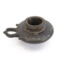Etruscan terracotta oil lamp, with black glaze, flat loop handle and laurel leaf border, the opening with later turned wooden collar, signed to base 'repaired by one James Naysmith 1887', H7cm 