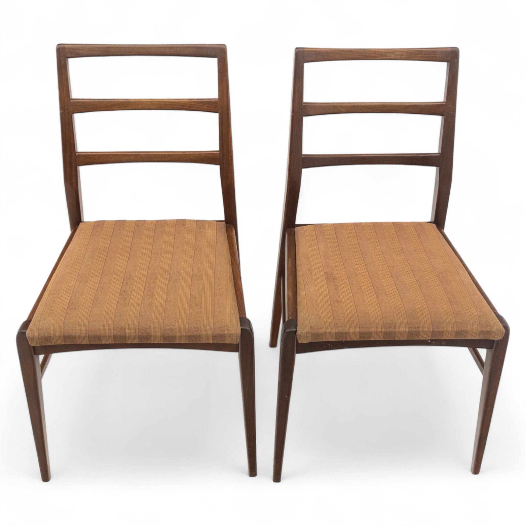 Richard Hornby for Fyne Ladye - mid-20th century afromosia teak dining table, tapered rectangular top with fluted edge and recess for spare leaf, raised on slender legs, four teak framed chairs, of ladder back design, with drop-in seat, upholstered seat, with tapered front legs and slightly raked rear legs,, table unextended width 106cm depth 79cm height 74cm with additional leaf 45cm wide- chairs width 48cm depth 41cm height 87cm 