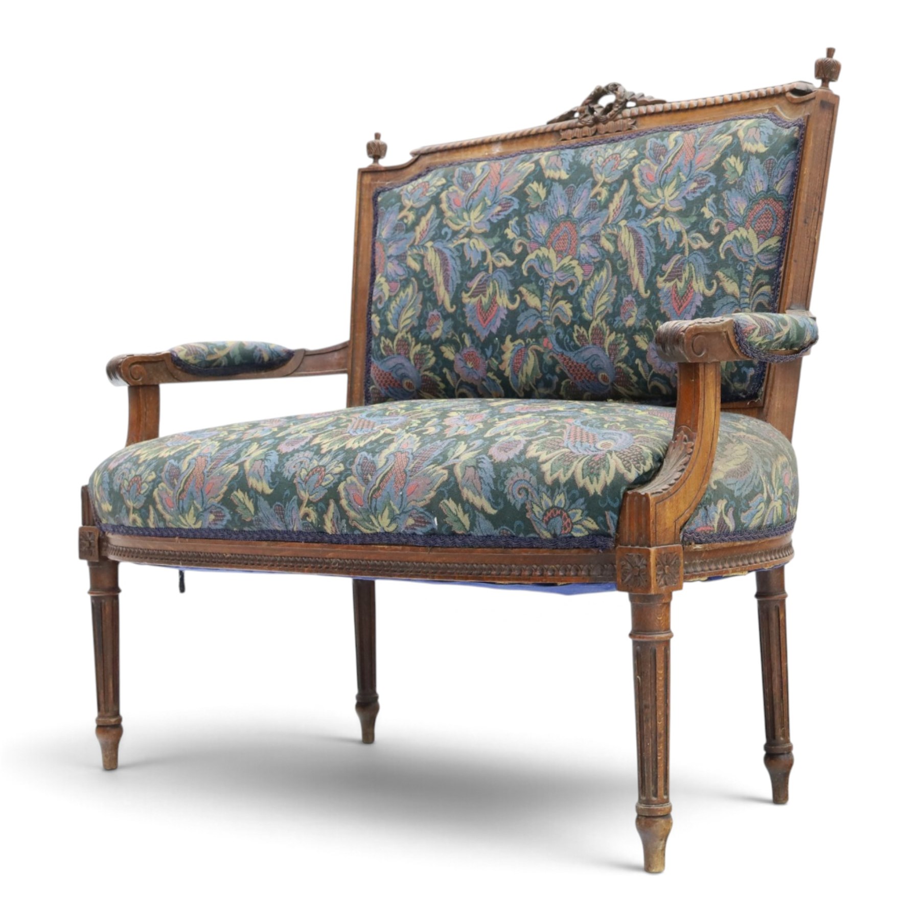 20th century French Louis XVI style stained beech two-seat salon settee, rectangular upholstered back and seat in floral tapestry fabric, carved and moulded frame with foliate cresting, padded open arms and fluted tapering supports