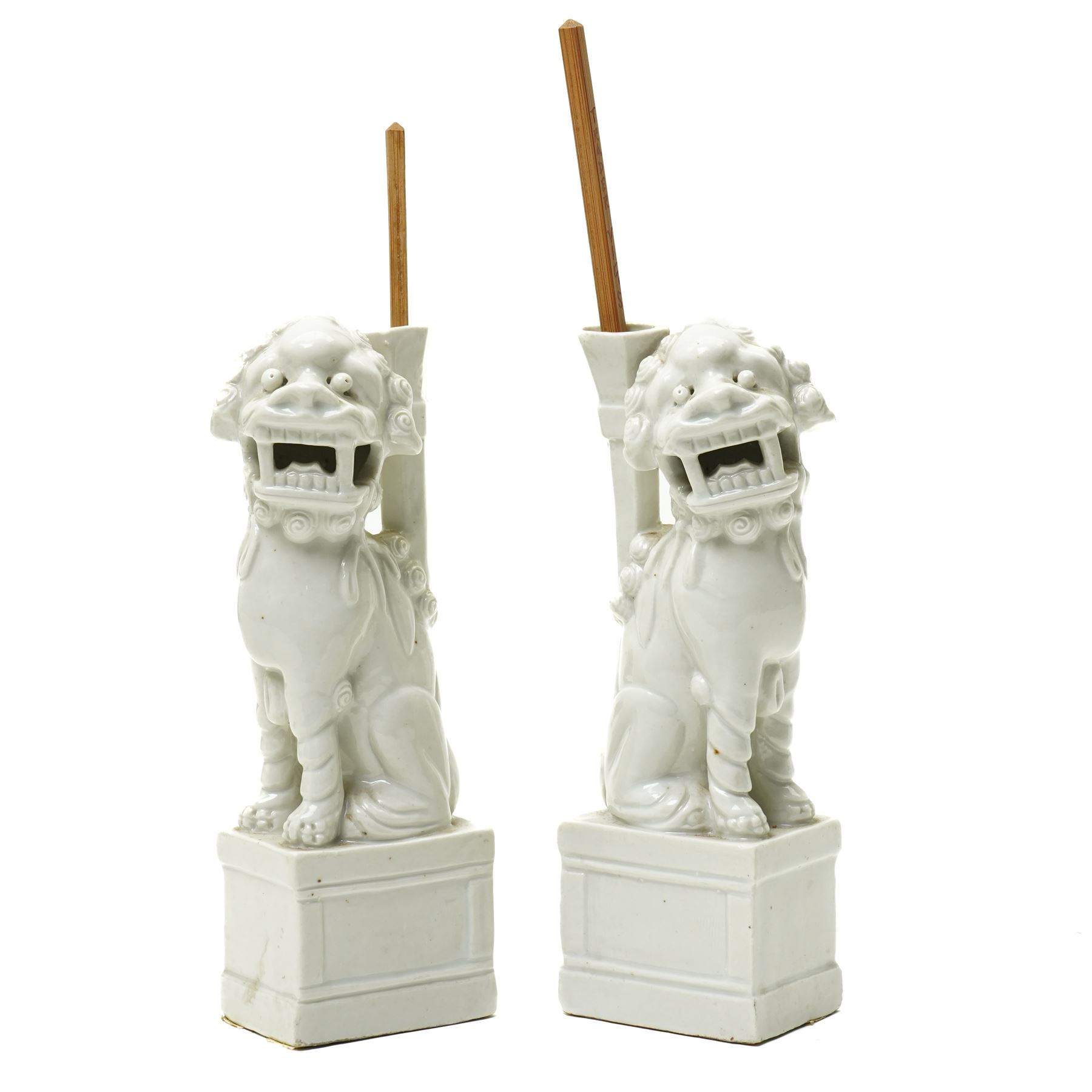 Pair of 19th century Chinese blanc de chine joss stick holders in the form of  Buddhist lions on rectangular bases H20cm (2)