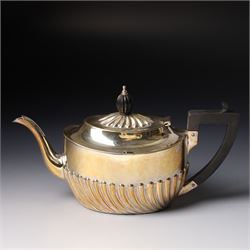 Late Victorian bachelors silver tea set of oval form with half body decoration, the teapot with ebonised handle and lift Sheffield 1895 Maker Harrison Bros. & Howson