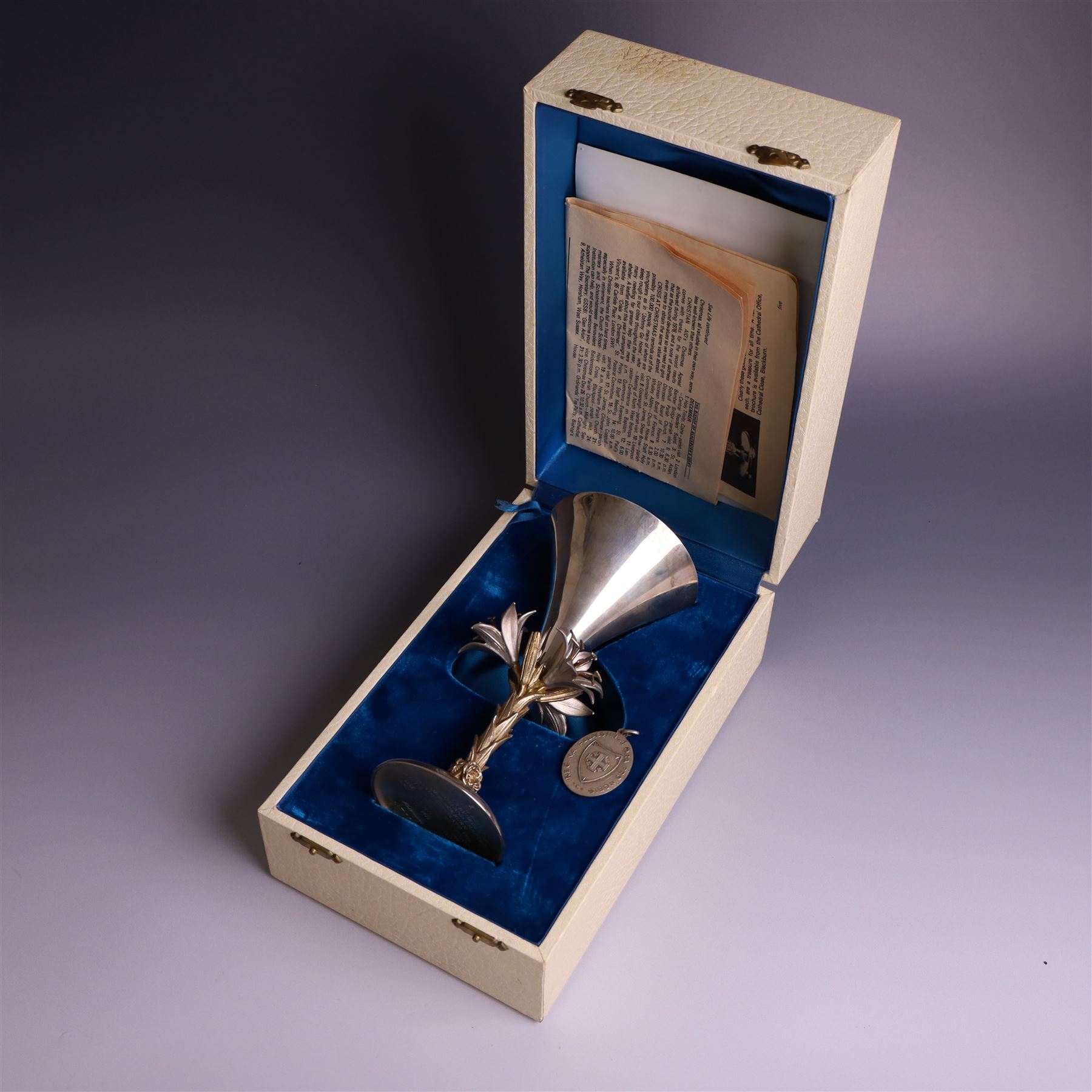 Modern limited edition silver goblet, 'made by order the provost and charter of Blackburn to commemorate the fiftieth anniversary of the cathedral in 1976 and its consecration in 1977' designed by Hector Miller for Aurum, the plain fluted cup, upon a stem of three lillies with parcel gilt highlihts and upon a circular foot, no. 2/750, hallmarked Hector Miller, London 1977, H17cm, boxed with certificate of authenticity