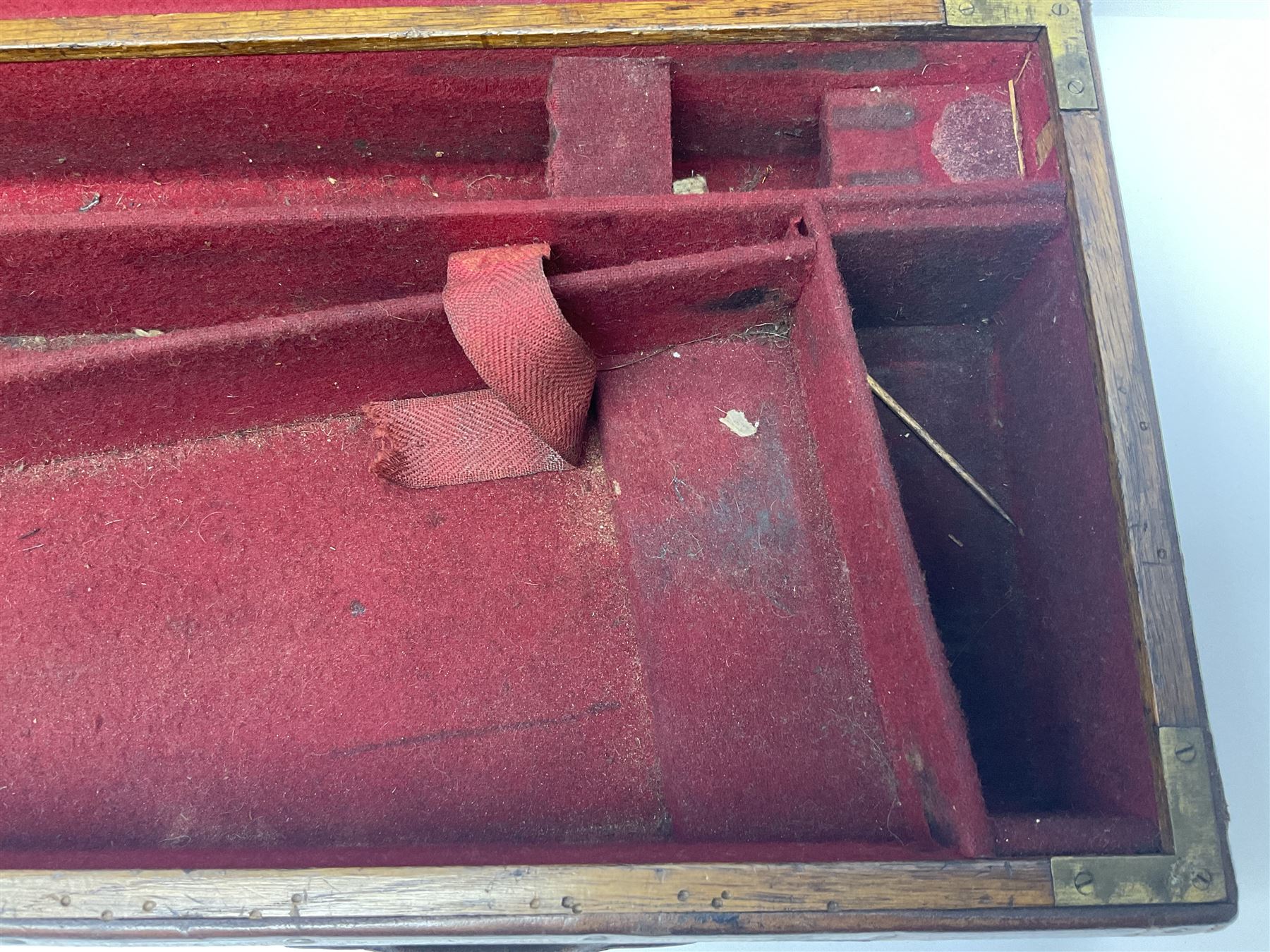 Leather shotgun case, the red baize lined interior with the trade labels of Westley Richards & Co., London, a brass plaque inscribed 'T Nevin, Mirfield, Yorkshire' to cover, with key, case to fit barrel 76cm (30 inches)  
