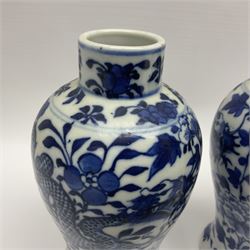 Pair of late 19th/early 20th century Chinese blue and white vases, each of baluster form, painted with dragons amidst flowers, each with Kangxi character marks beneath, H14cm 