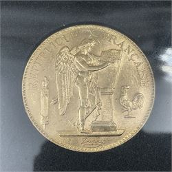 France 1906 gold one-hundred francs coin, housed in a display case
