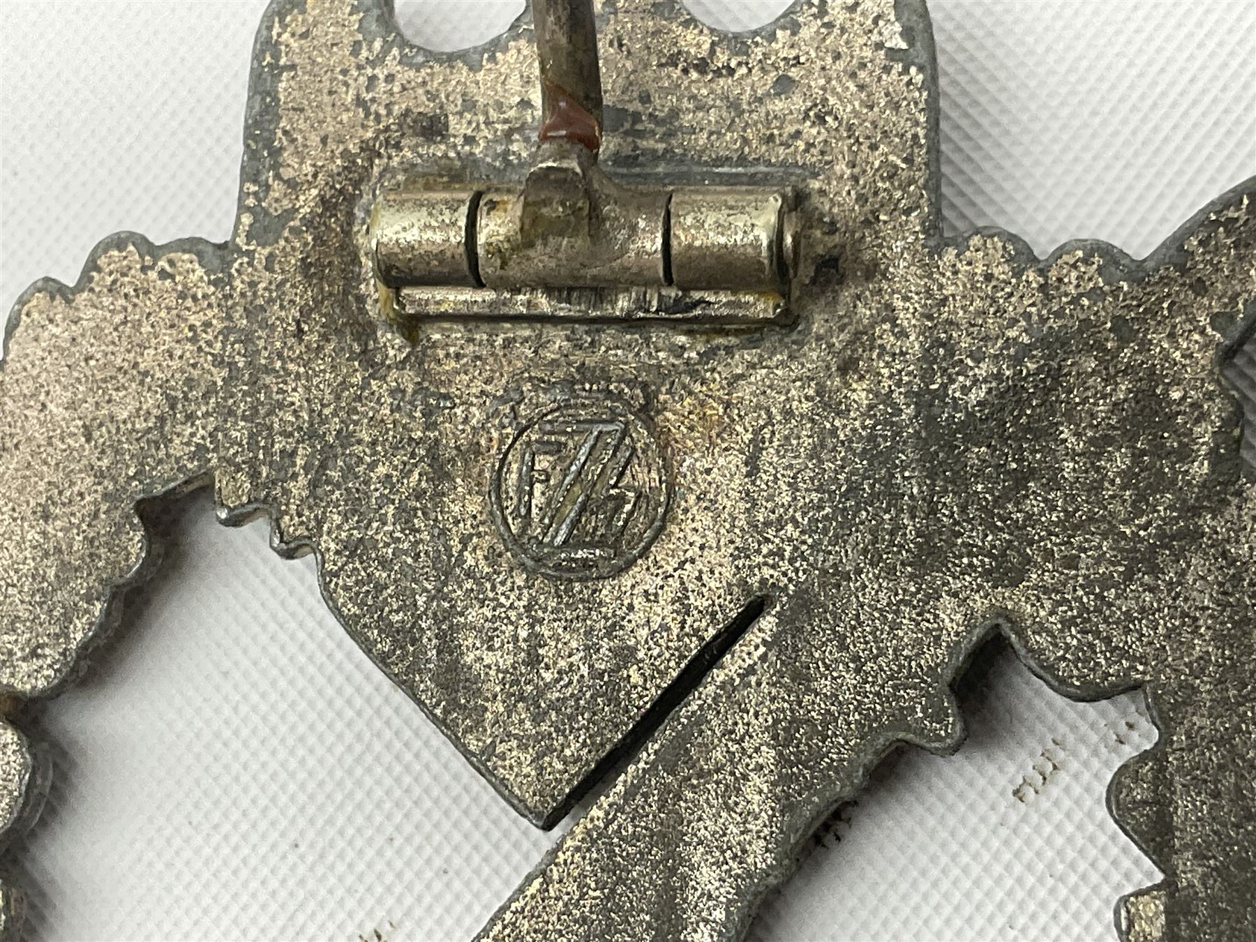 Three WW2 German badges comprising Blockade Runner War Badge and Coastal Artillery badge, both marked 'Fec Otto Placzec Berlin'; and Infantry Assault Badge; all with fixing pins (3)