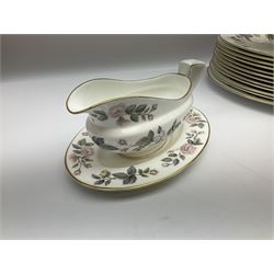 Royal Worcester June Garland pattern tea and dinner wares, comprising thirteen dinner plates, twelve dessert plates, twelve side plates, six twin handled soup bowls and six saucers, six small bowls, sauce boat and stand, thirteen teacups and fifteen saucers, open sucrier, and milk jug