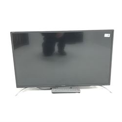 Sharp LC-32CFE6351K television with remote control