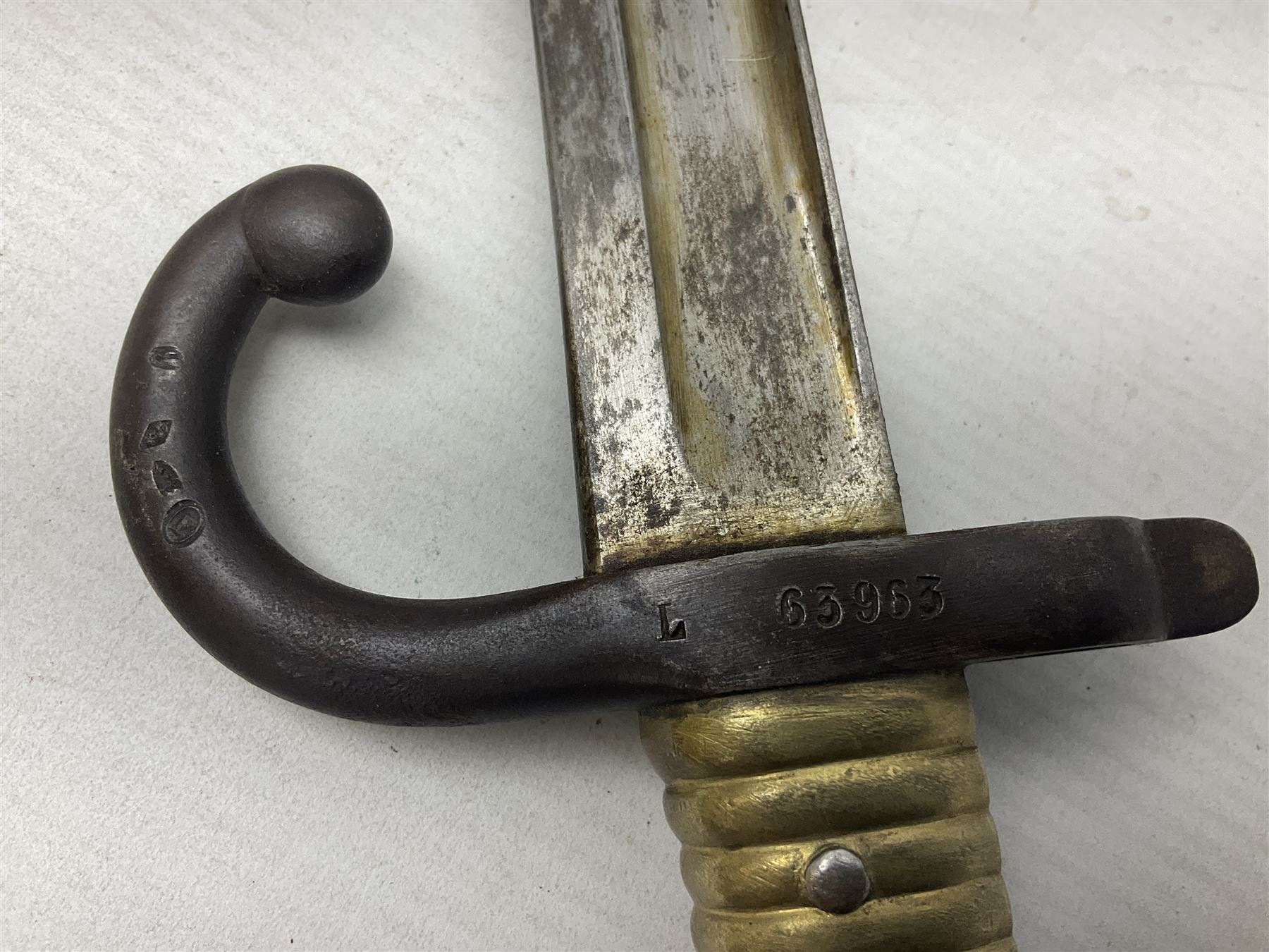 French Model 1866 Chassepot bayonet with 57cm curving fullered steel blade dated 1873 No.L63963; in steel scabbard with conforming number L71.5cm overall; and French St. Etienne Gras bayonet dated 1878 No.K10674 in steel scabbard numbered 79437 (2)