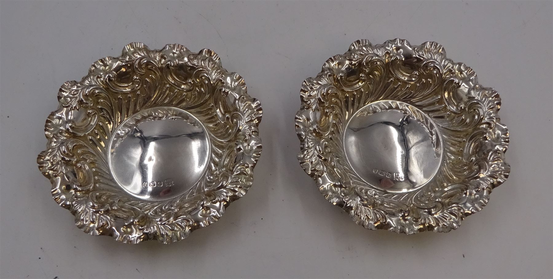 Pair of Victorian silver bon bon dishes, each of circular form, with shaped rim and repousse scroll decoration, hallmarked Fenton Brothers Ltd, Sheffield 1897, in tooled leather velvet and silk lined fitted case