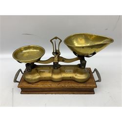 Pair of gilded iron scales mounted on wood twin handled base with drawer and quantity of brass weights