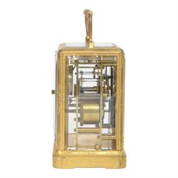 Late 19th century French 8-day brass cased carriage clock, Henry Marc of Paris, the gorge case with swing handle and four bevelled glass panels, white enamelled dial with Roman numerals and minute markers and steel hands, the two train movement with platform lever escapement, hour striking on a bell, with key