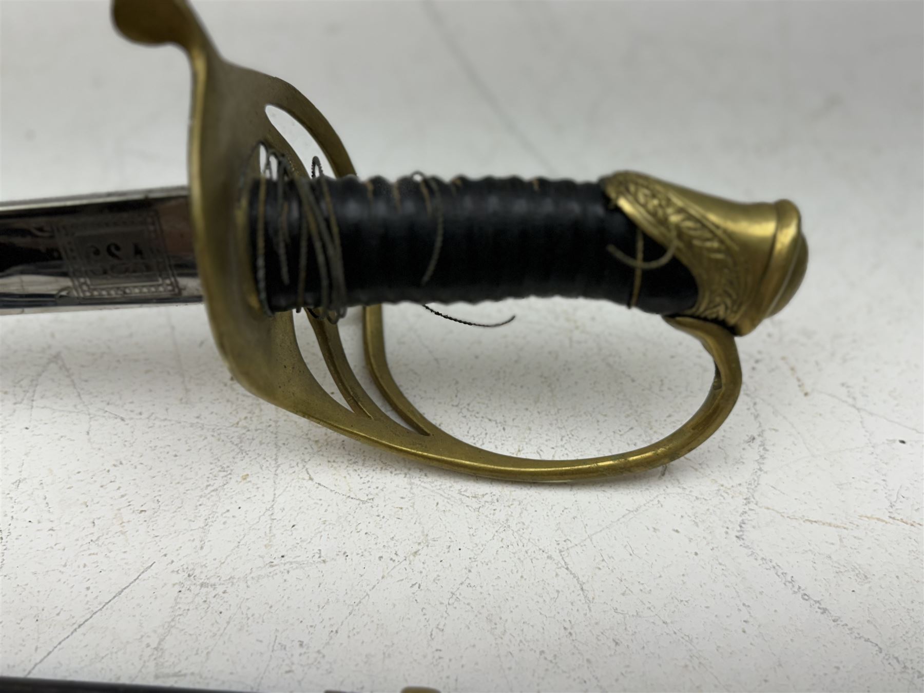 Replica Confederate States Army officer's sword, with brass pommel, black leather hand grip, the 85cm single edged blade marked CSA, in a metal and brass scabbard, L106cm