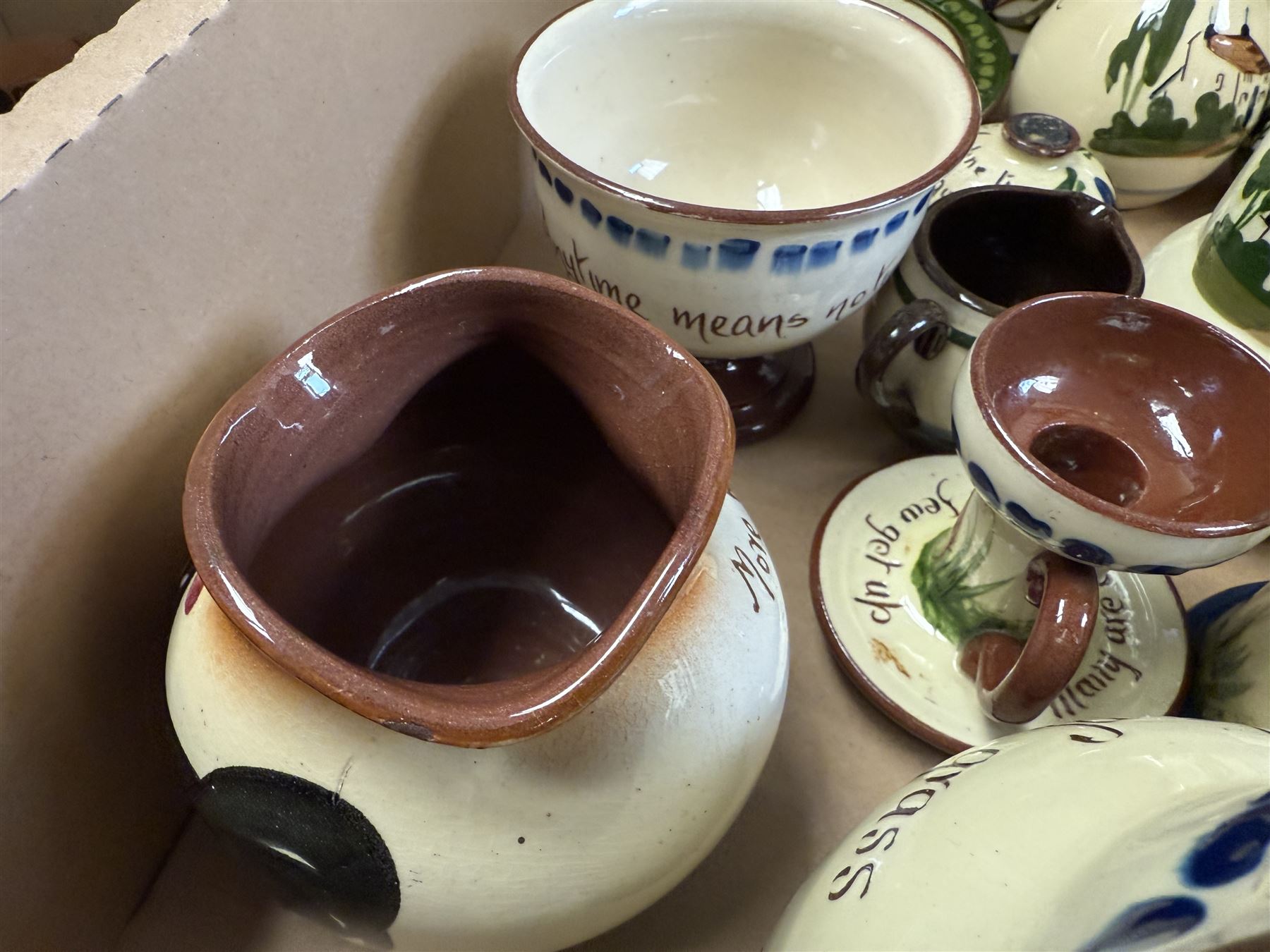 Collection of Torquay and similar Motto ware, including jugs, candlesticks, twin handled mug etc 